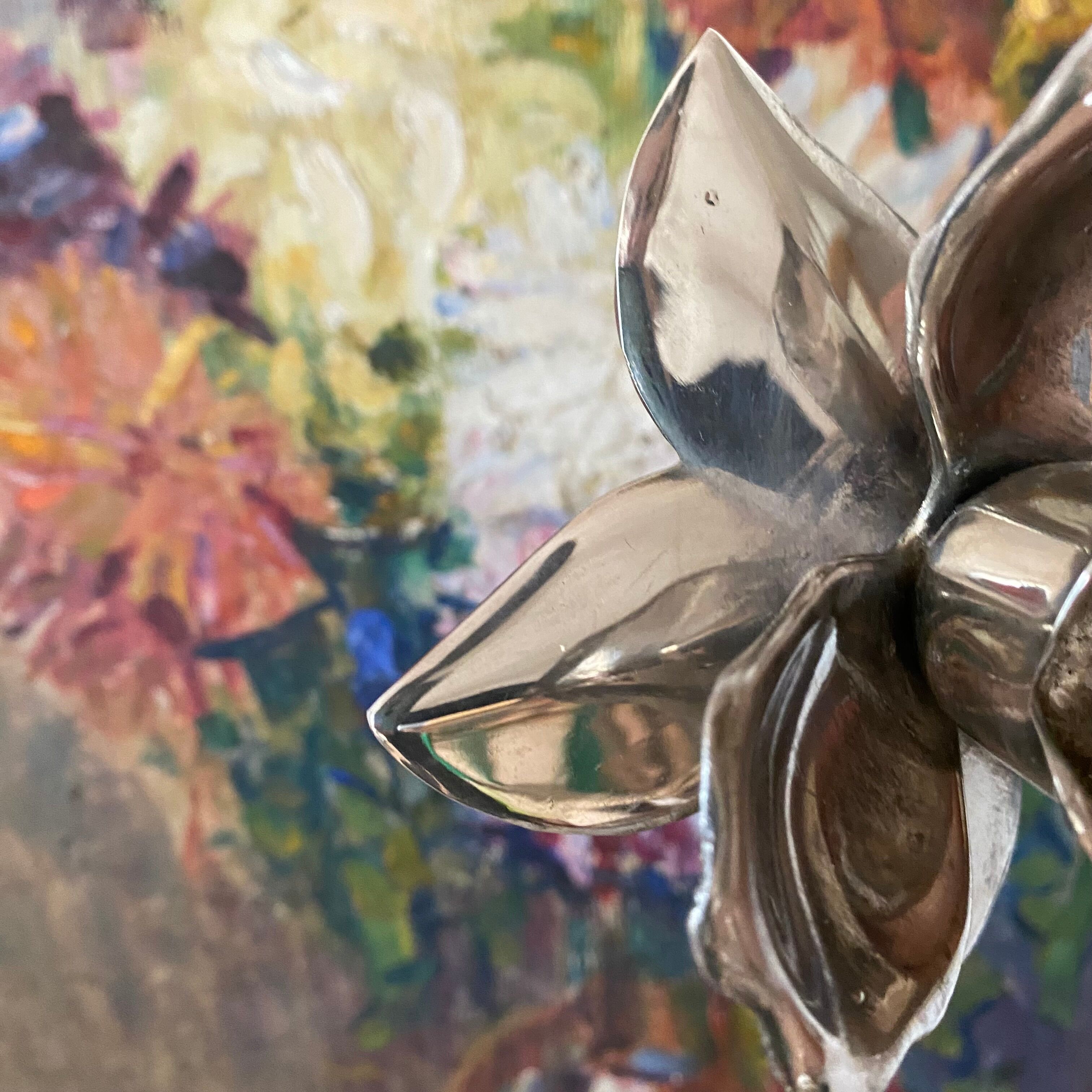 Pair of silver metal flower candle holders