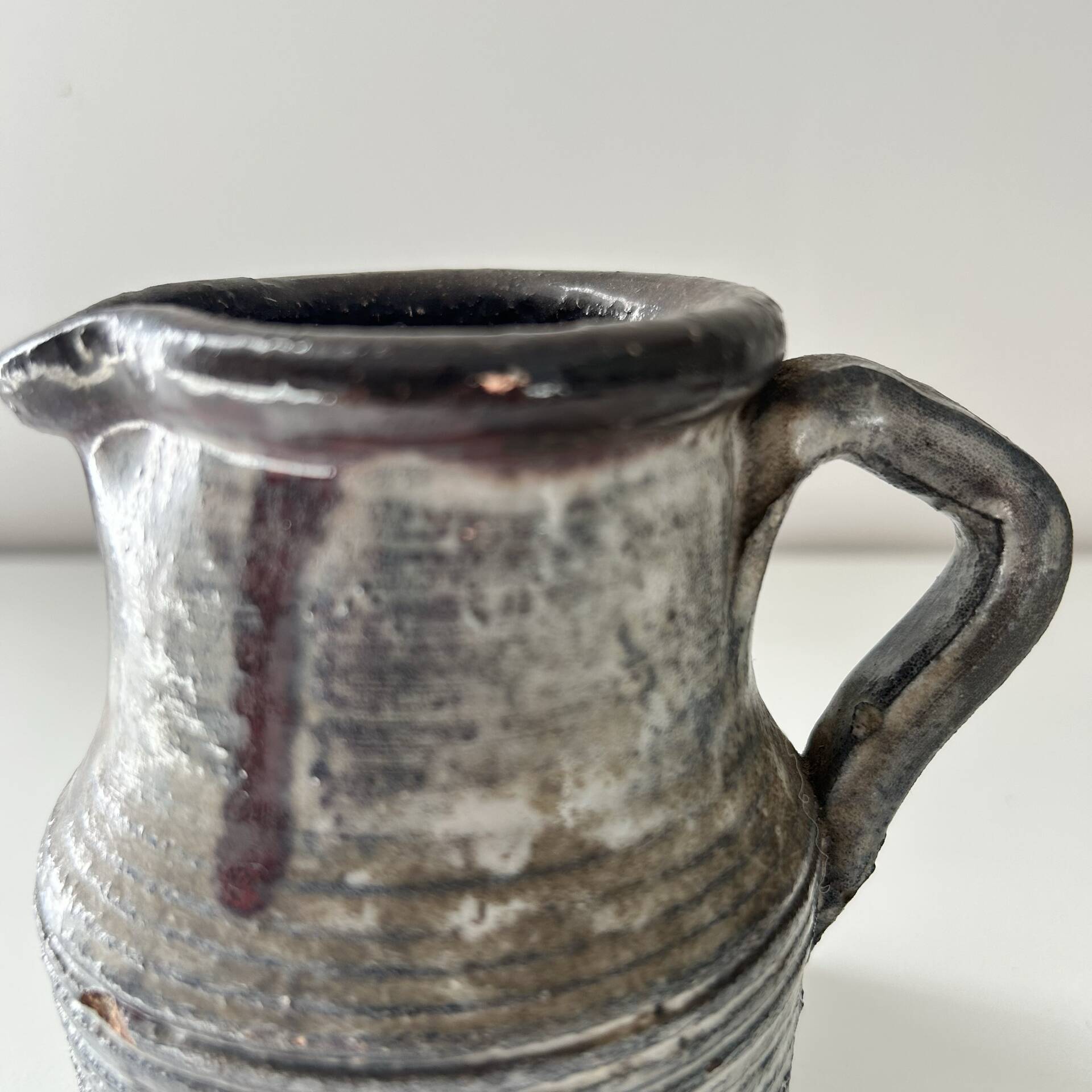 Patinated pitcher signed