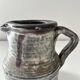 Patinated pitcher signed