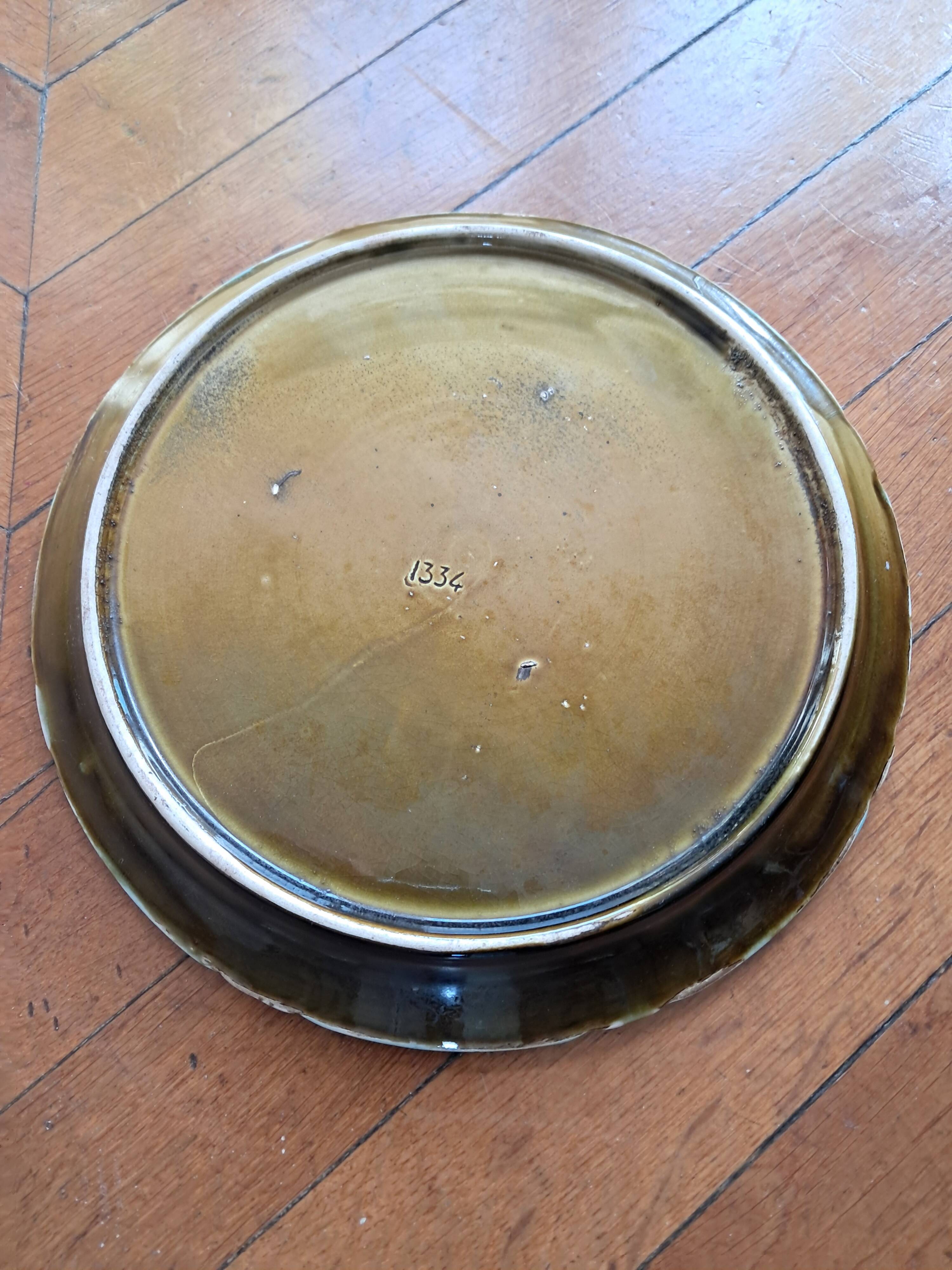 Vintage barbotine plate by Gustave de Bruyn.