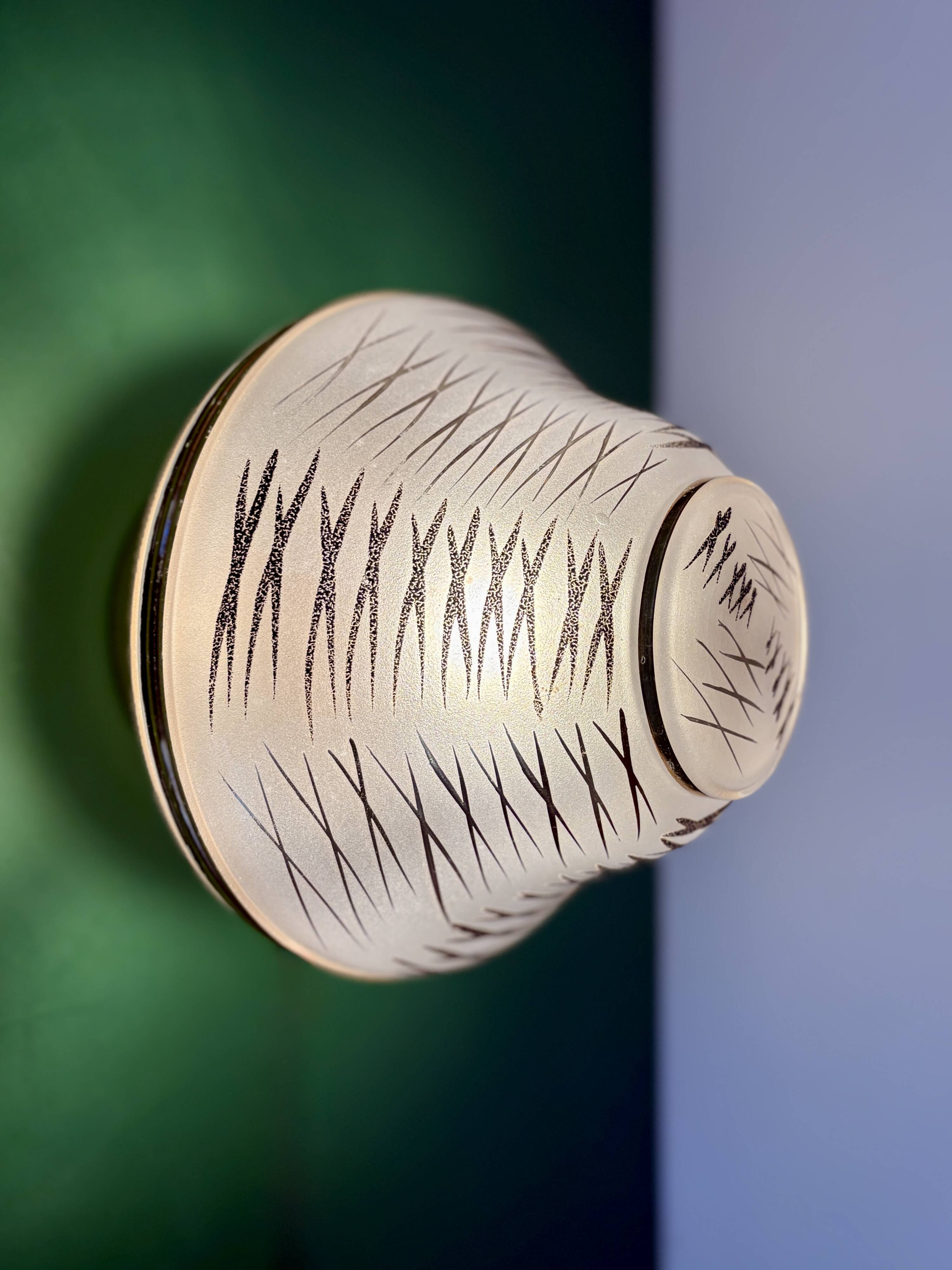 Vintage Art Deco globe wall/ceiling light in white, black, and gold glass.