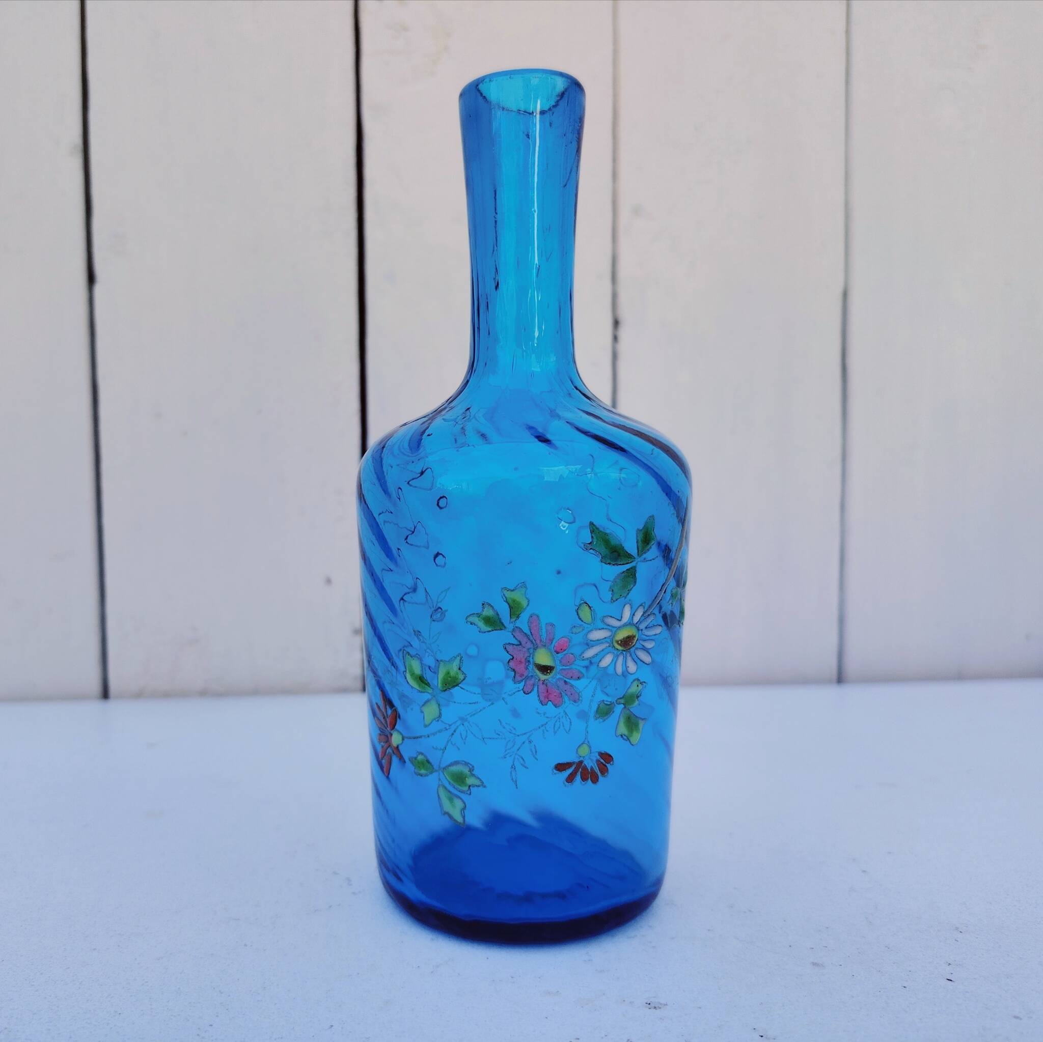 Vintage twisted blue glass carafe with enamel decoration.