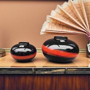 A pair of black and red spherical vases by Bay Keramik, West Germany, from the 1960s.