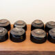 Set of 8 black ceramic cups signed