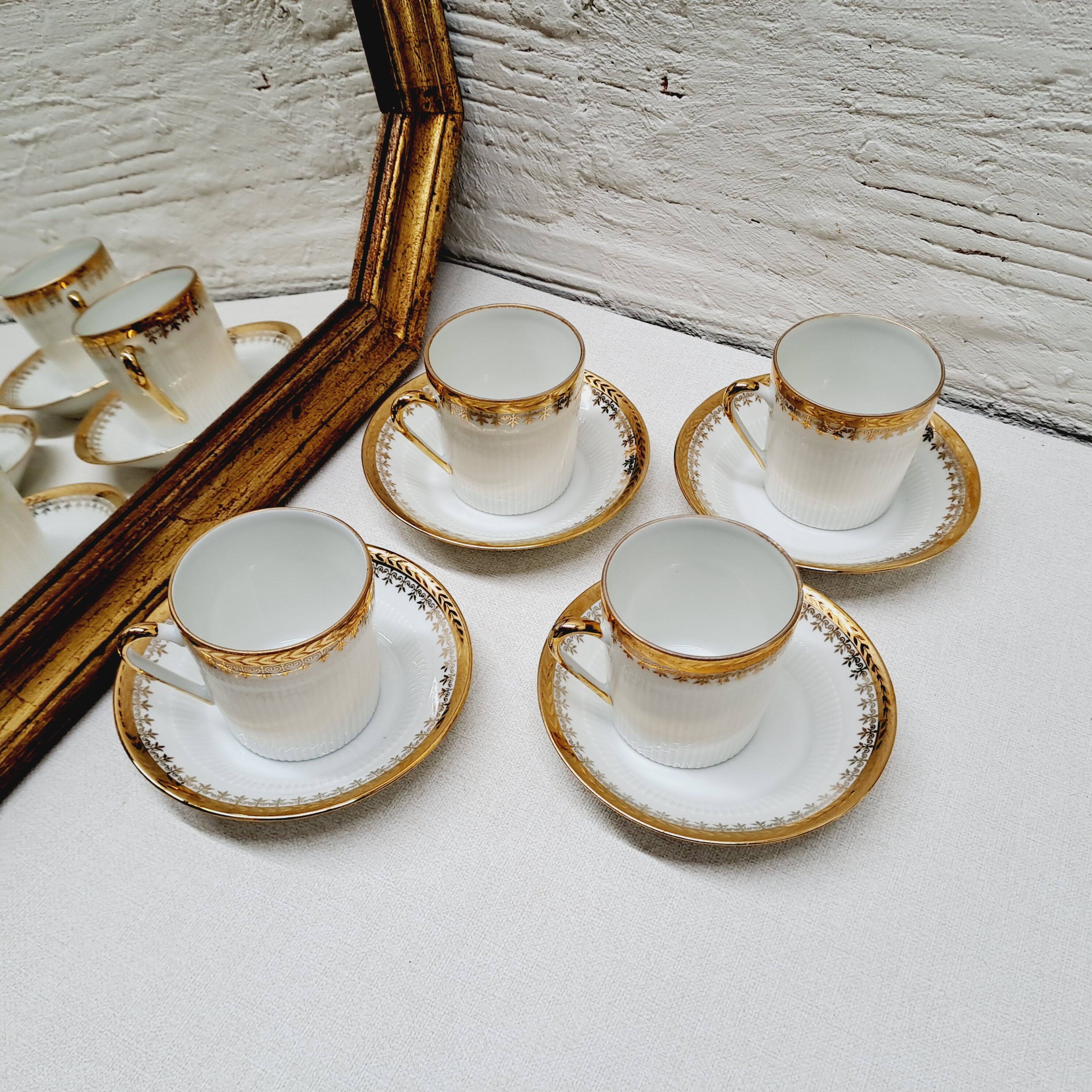 White and gold porcelain coffee maker and cups