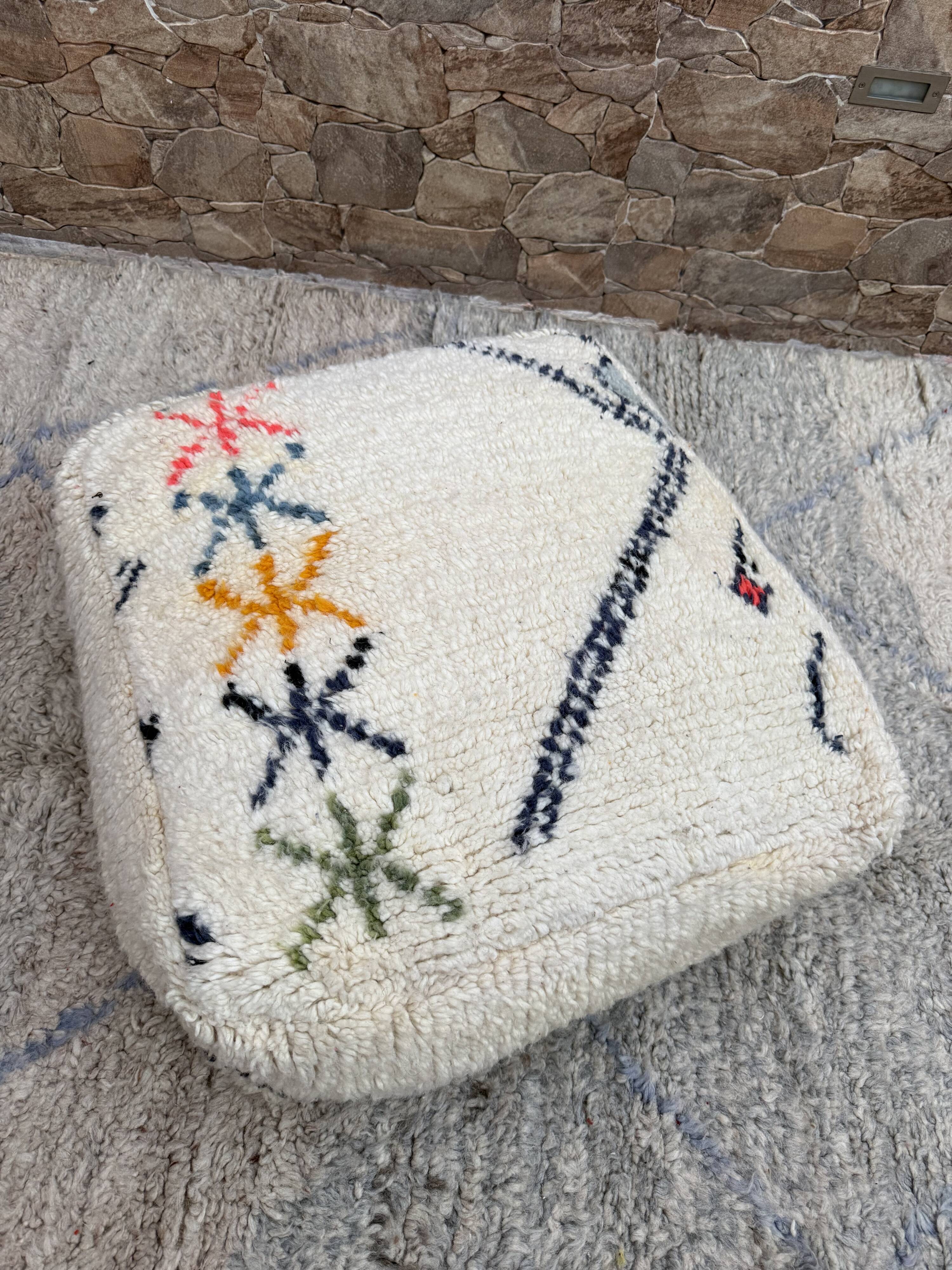 Berber floor pouf: Handwoven Moroccan wool cushion.