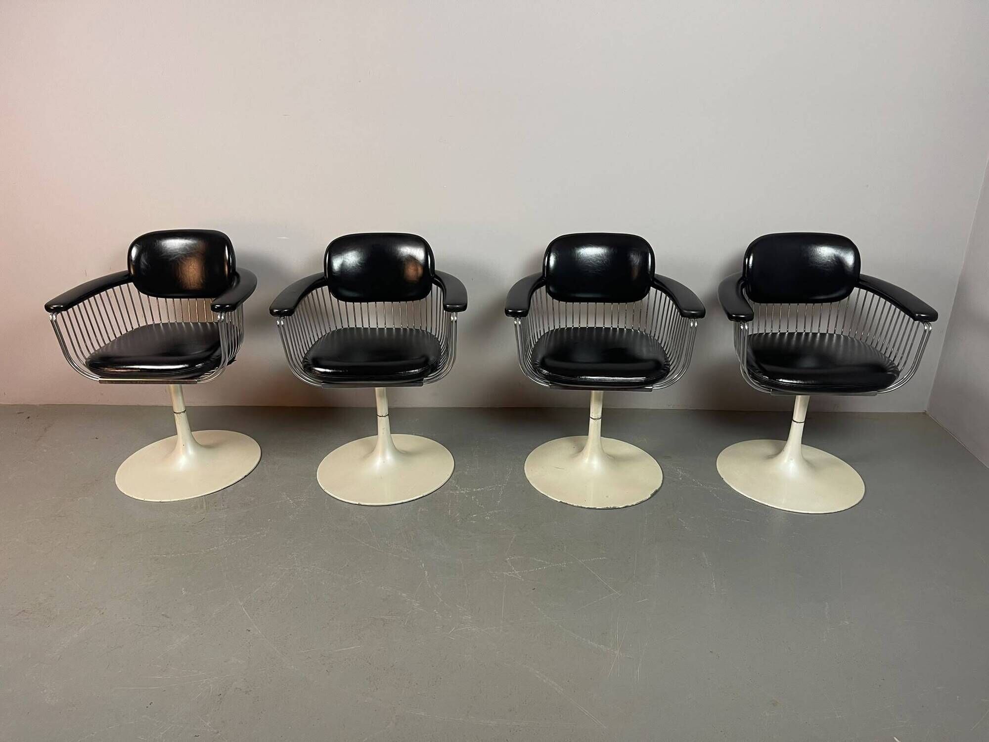 A striking set of four vintage swivel dining chairs