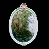Vintage oval mirror in carved wood in pastel tones