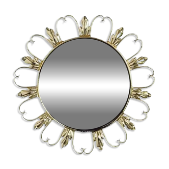 Round mirror on a brass frame with scrolls