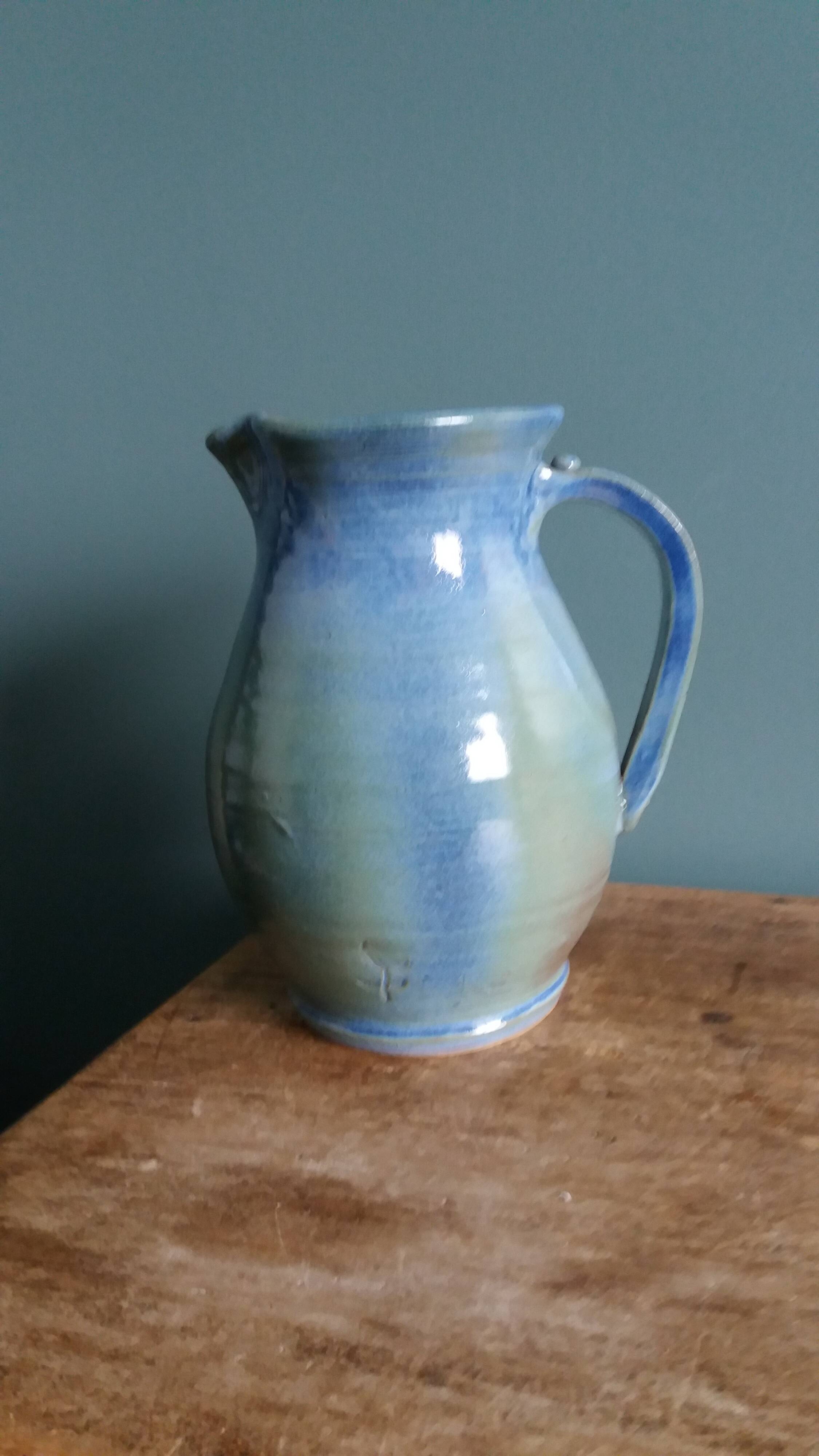 Enamel pitcher in pastel blue and green, signed