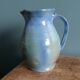 Enamel pitcher in pastel blue and green, signed
