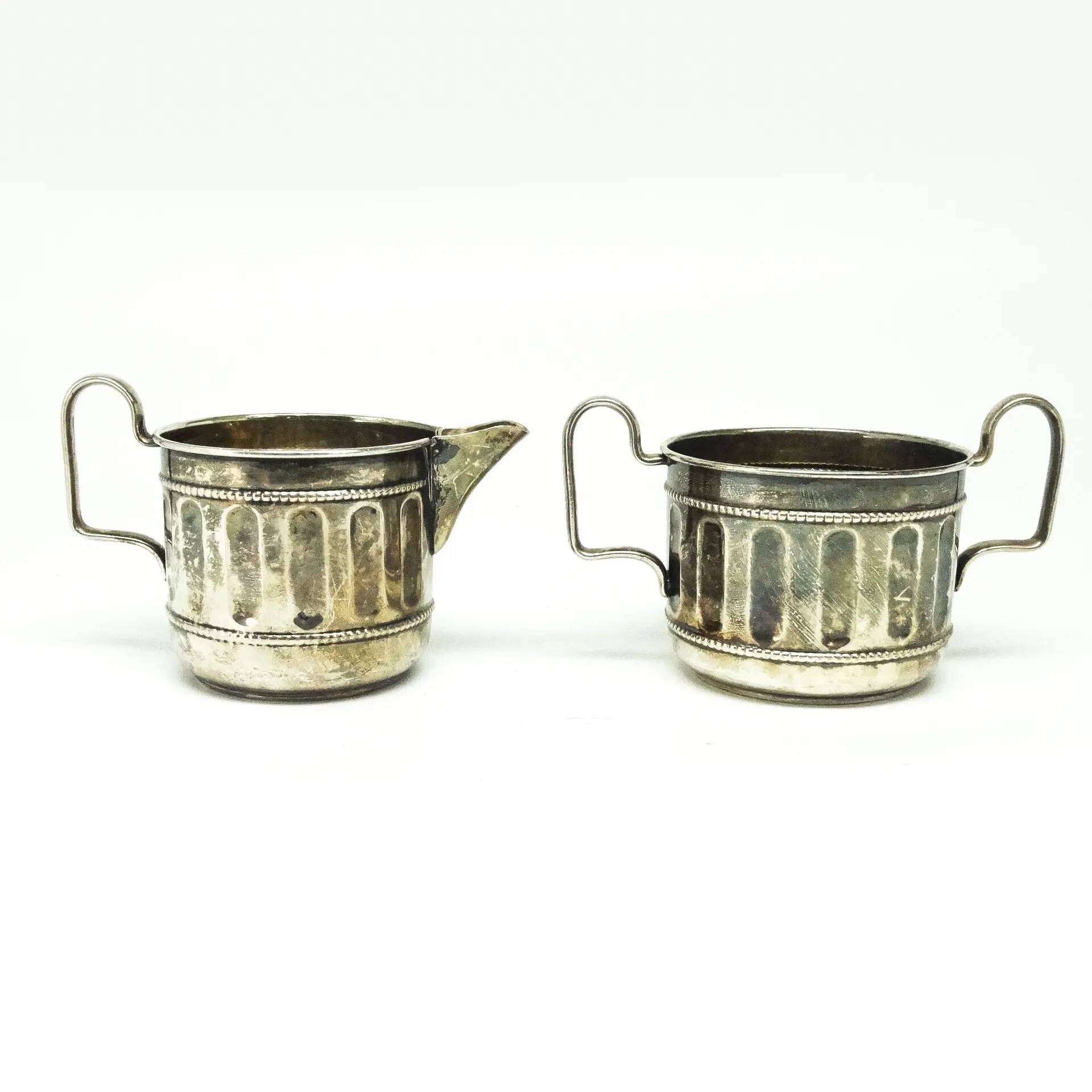 Set of sugar bowl and milk jug, neoclassicism with art deco influences, silver-plated brass, Belgium, 1930s.