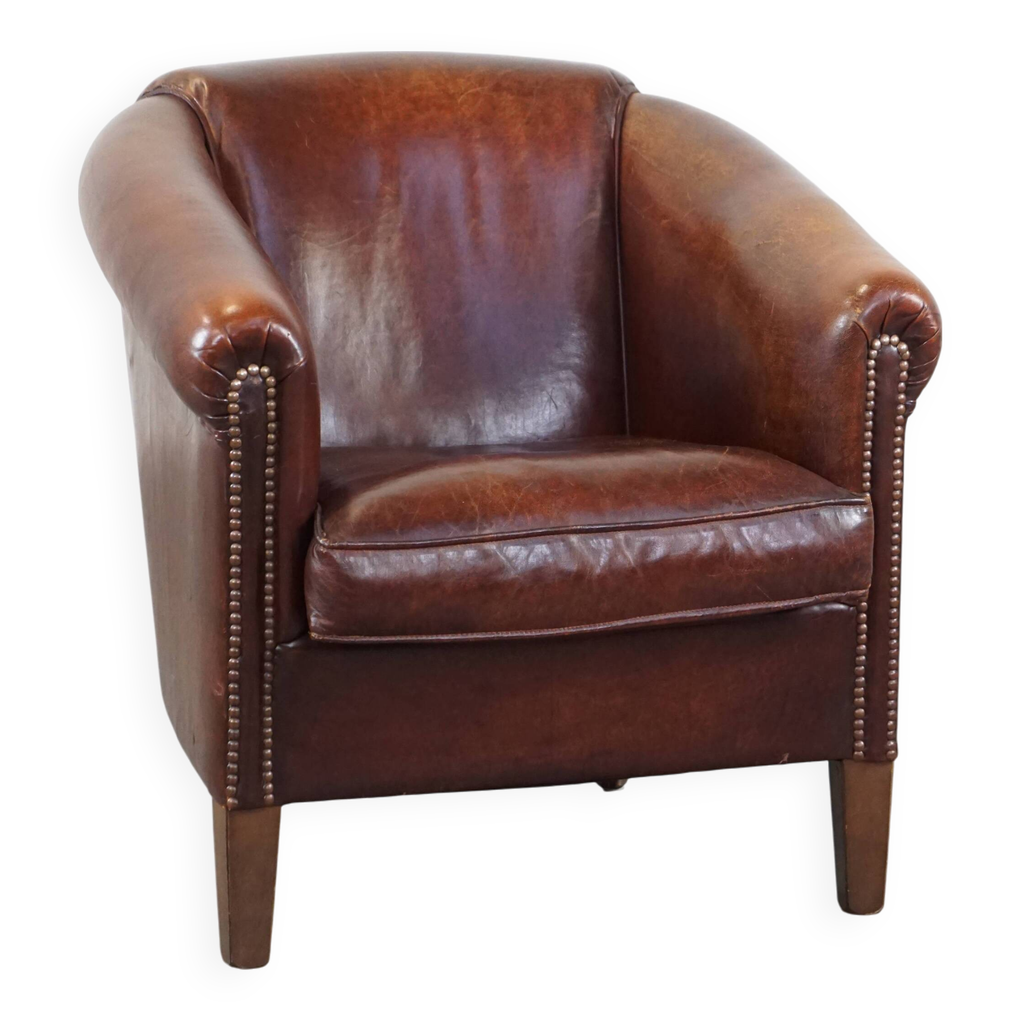 Sheepskin club armchair, correct finishing with decorative nails