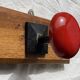 Wall-mounted coat rack with 3 hooks, vintage 1960s red lacquered metal.
