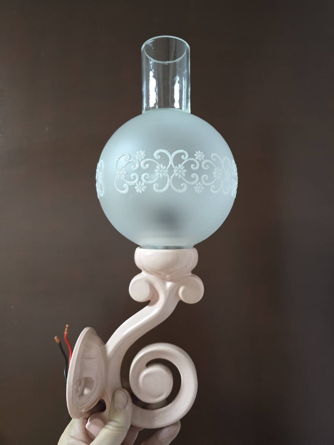 Original wall lights in pink enamelled cast iron with frosted glass globes.