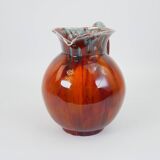 Large red and blue glazed ceramic pitcher signed Delène under the base