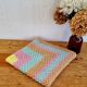Vintage pastel crochet blanket for children.