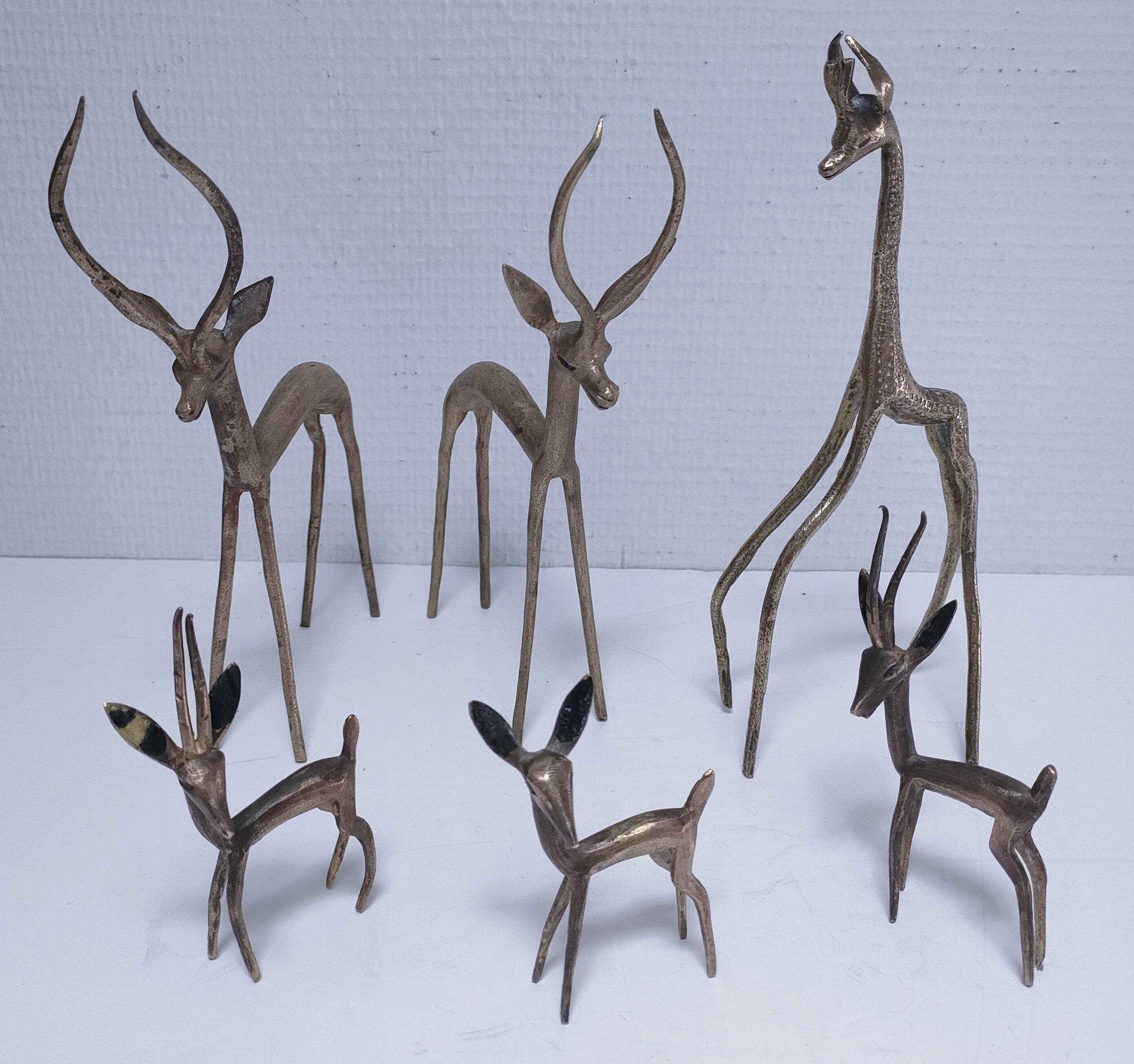 five vintage brass sculptures of gazelles, antelopes, and a giraffe