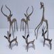 five vintage brass sculptures of gazelles, antelopes, and a giraffe