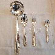 Silver cutlery set for 36 place settings and its ladle.