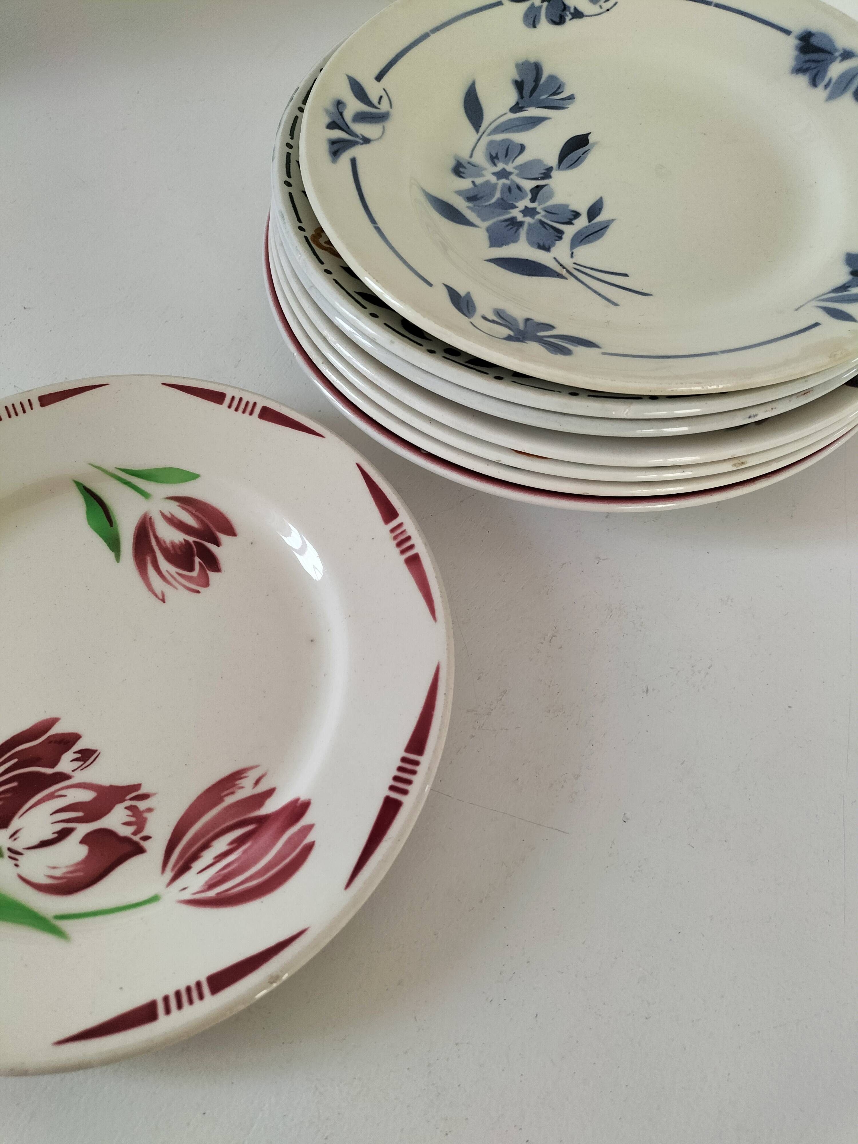 Set of 8 ironstone plates with coordinated designs.