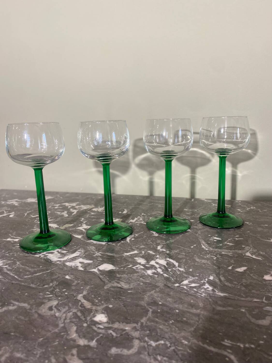 4 green stemmed glasses