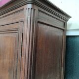 Bonnetière man standing cabinet a door