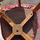 Set of 4 vintage bistro chairs in wood and red faux leather, with splayed legs.