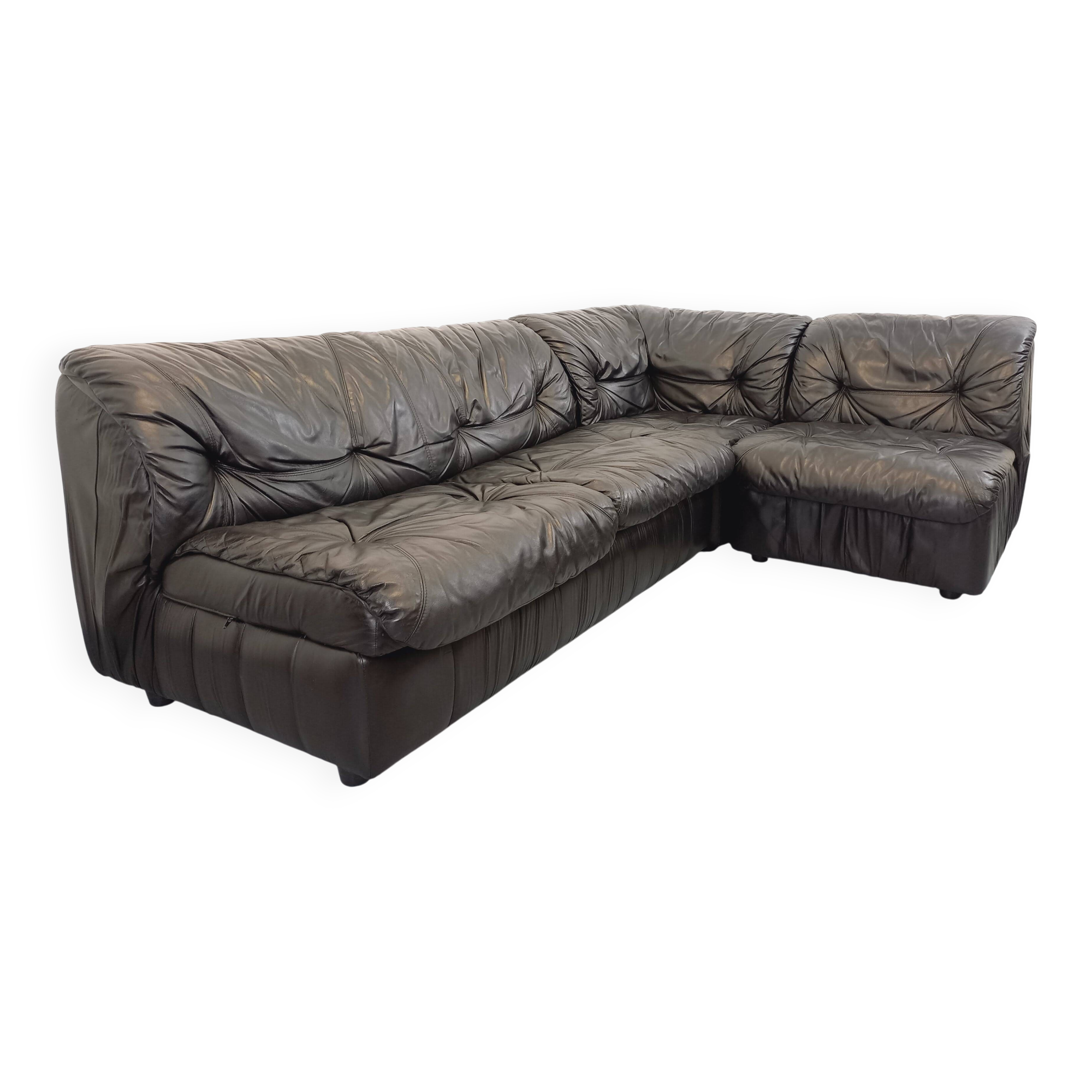 Vintage corner sofa composed of 3 modules in black leather with integrated bed.