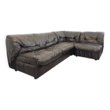 Vintage corner sofa composed of 3 modules in black leather with integrated bed.