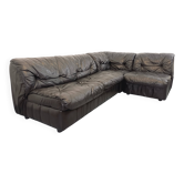 Vintage corner sofa composed of 3 modules in black leather with integrated bed.