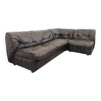 Vintage corner sofa composed of 3 modules in black leather with integrated bed.