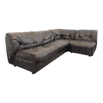 Vintage corner sofa composed of 3 modules in black leather with integrated bed.