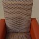 Vintage rockabilly retro armchair in orange faux leather and fabric.