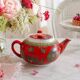 Vintage red Chinese teapot decorated with dragons and symbols.