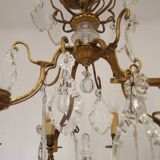 French Louis XV chandelier with 8 lights in gilded bronze, glass and crystal.