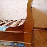 Bed with cherry wood base and bedside table