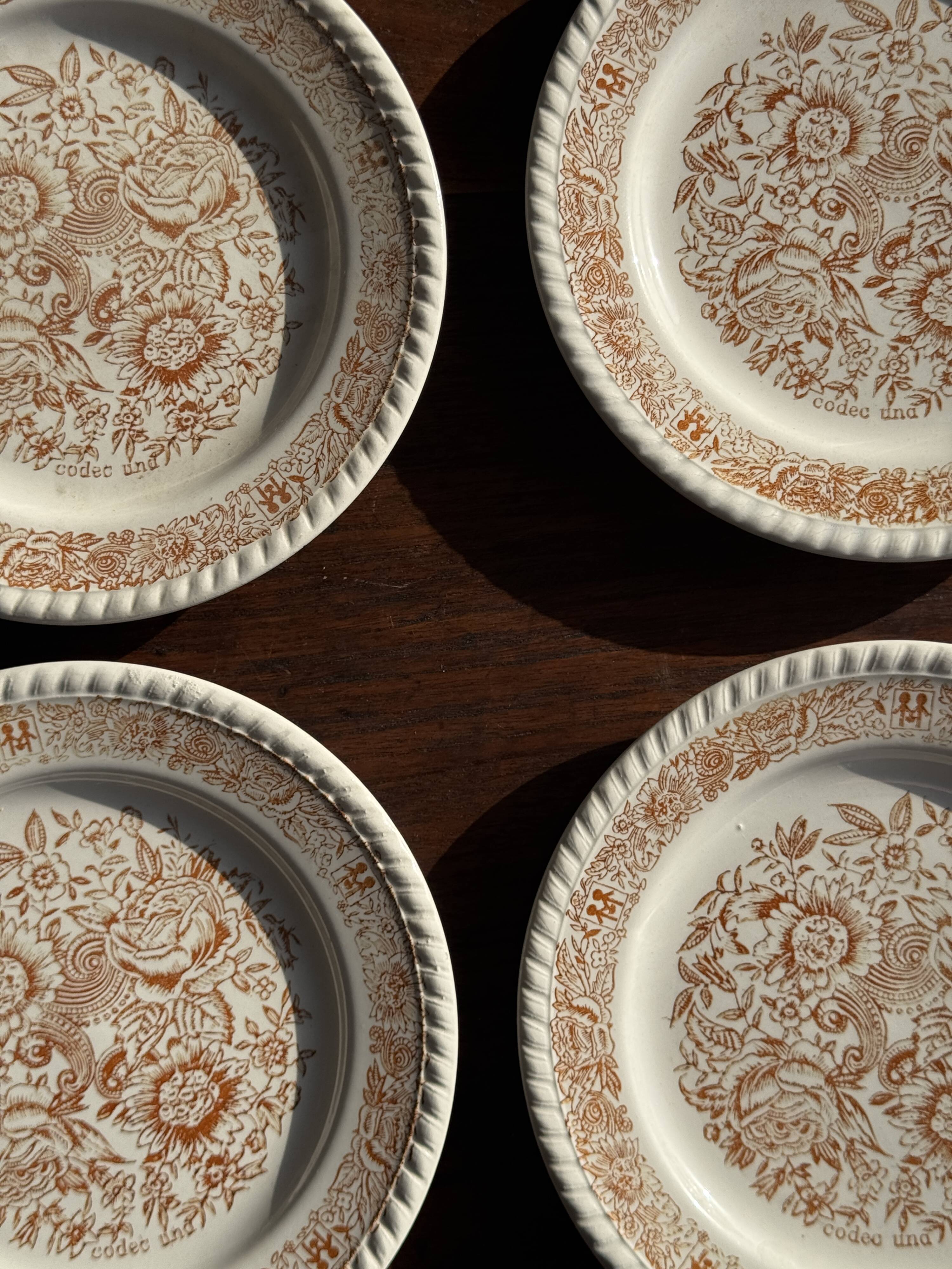 Set of 4 small dessert plates with a vintage stylised flower pattern.