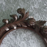 Wooden oval frame with carved pediment