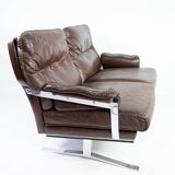 Two seater sofa upholstered with patinated brown leather and frame in metal, designed by Arne Norell