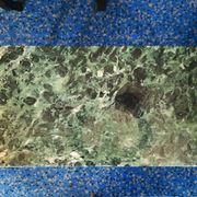 Coffee table in gilded bronze and green Alpine marble
