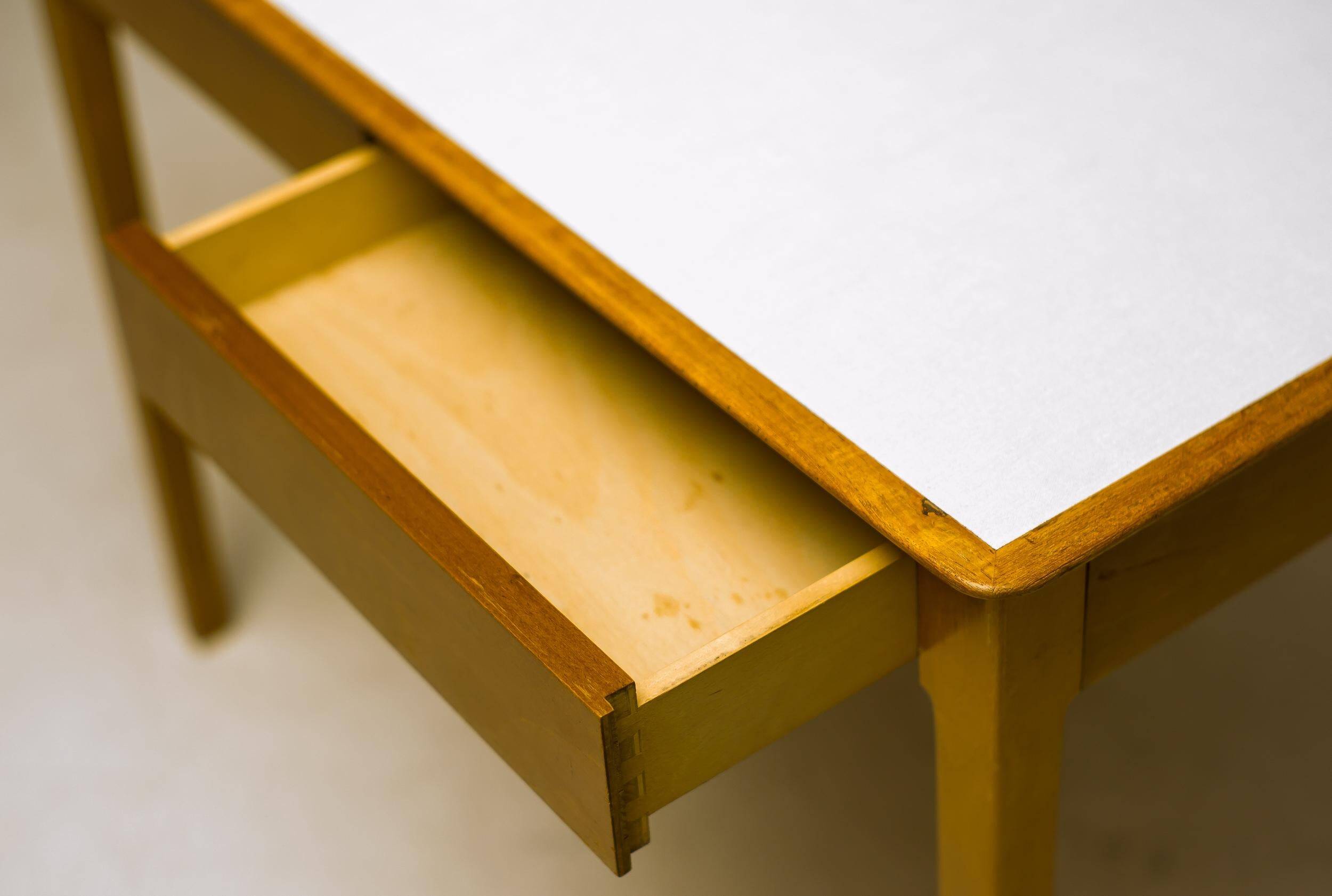 Small maple desk with a laminate top and two drawers, Fritz Hansen, 1950s.