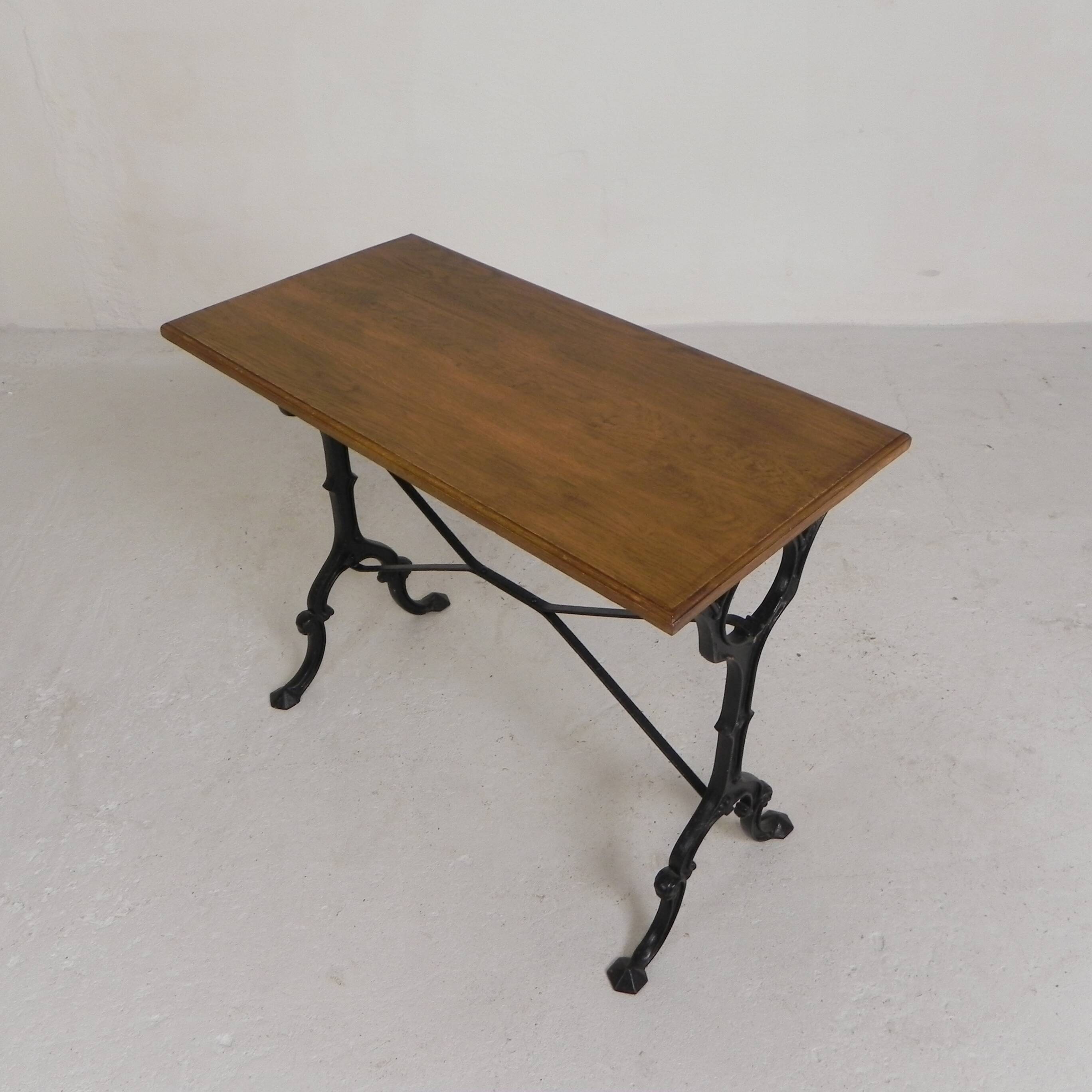 Bistro table with an oak top on a cast iron base, 1930s.