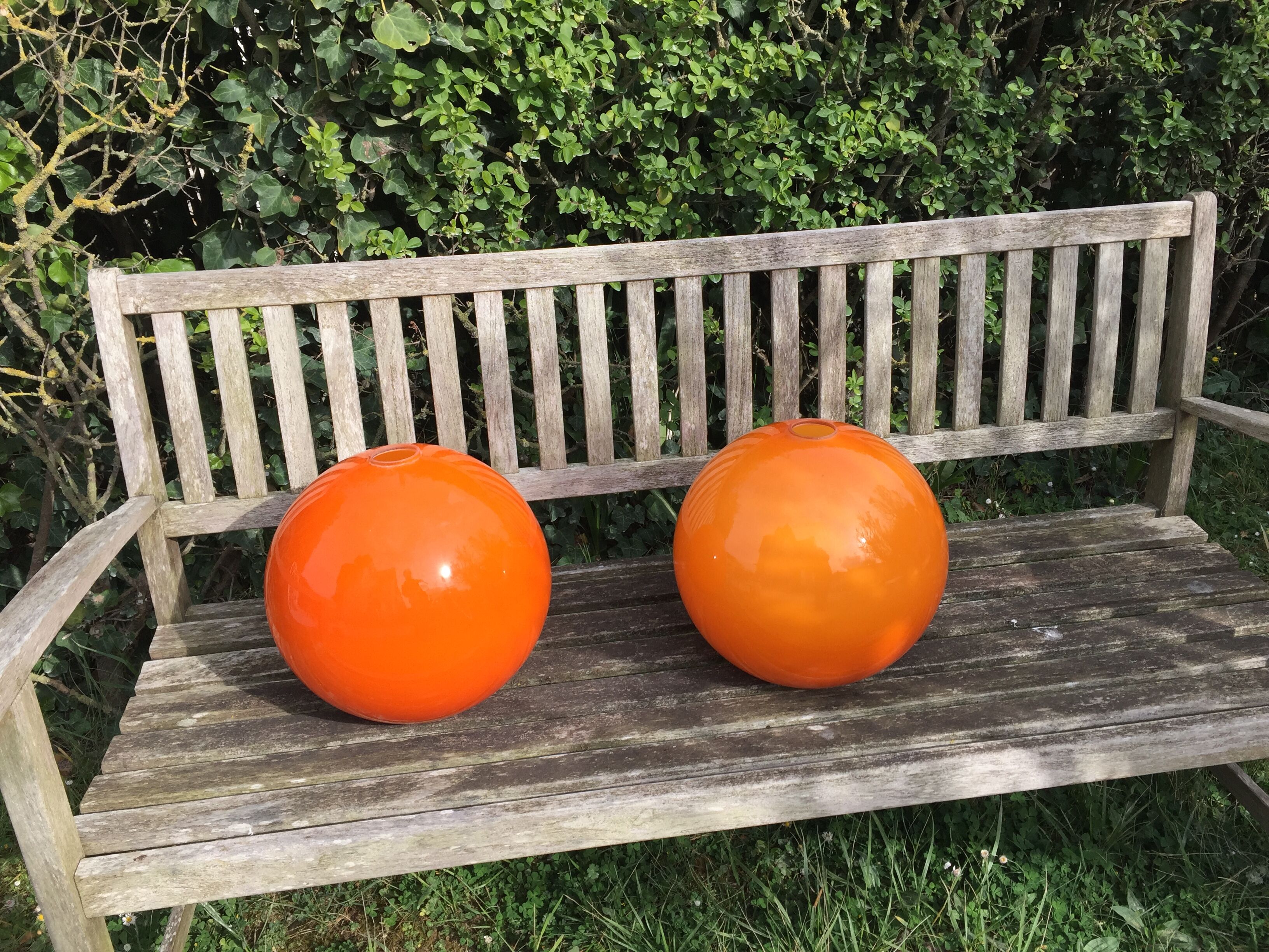 Two orange opaline globes, 30 cm diameter