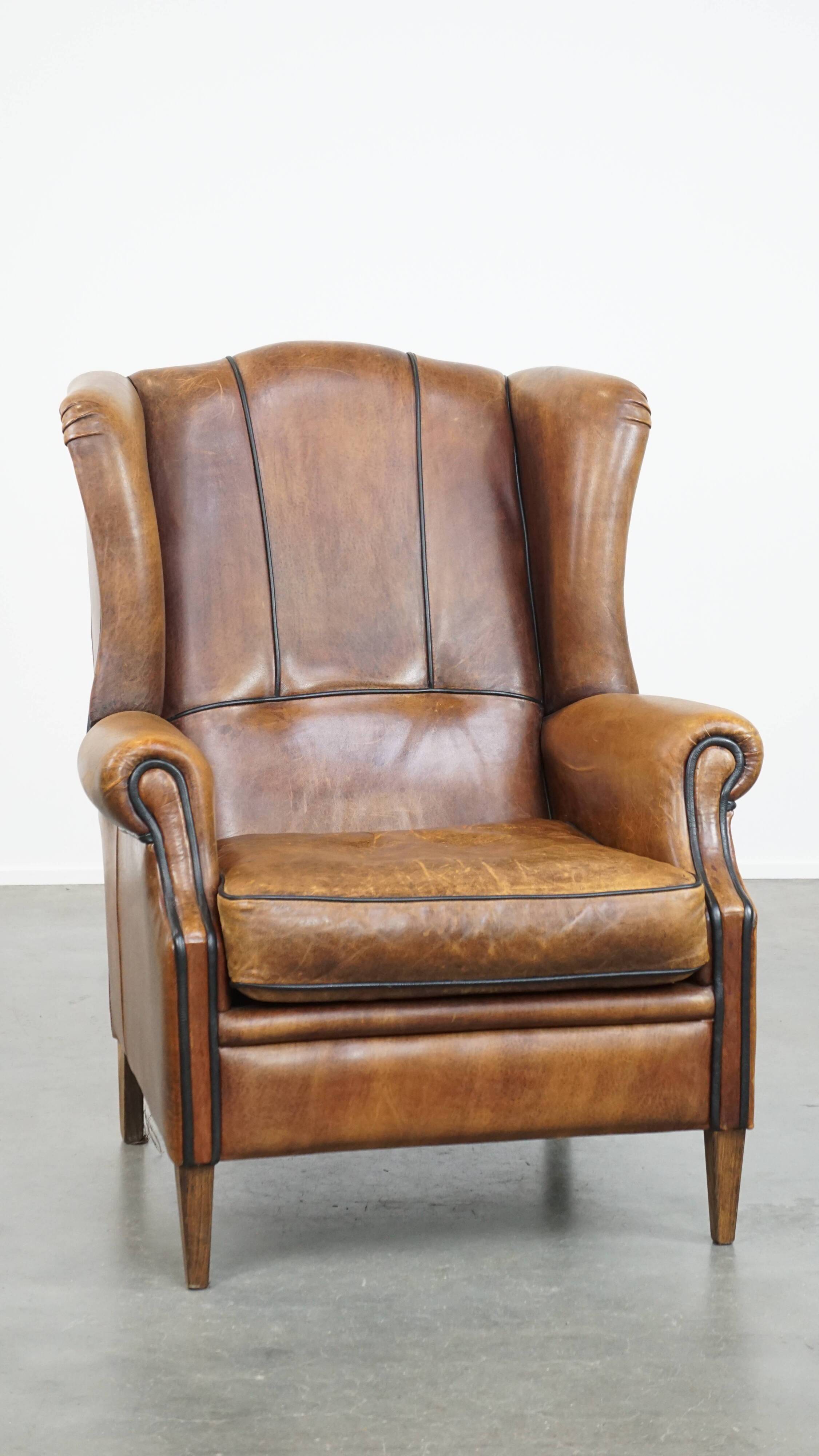 Sheep leather wingback chair finished with black piping