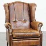 Sheep leather wingback chair finished with black piping