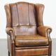 Sheep leather wingback chair finished with black piping