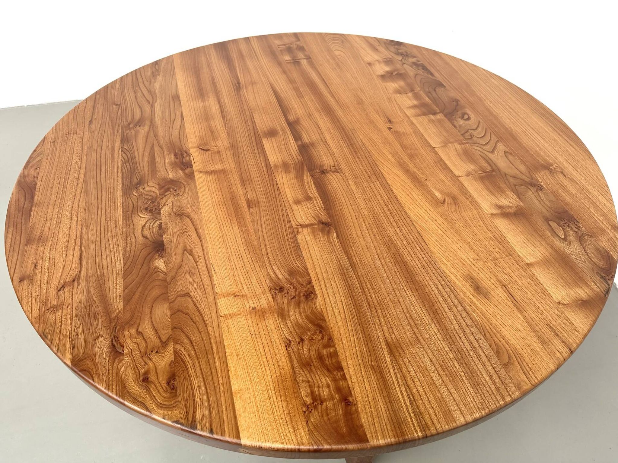 Table ronde moderniste en orme massif, piètement croisé