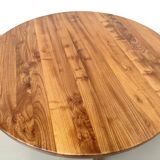 Modernist round table in solid elm, crossed legs.