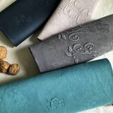 Set of four old damasked and monogrammed napkins, dyed in multiple colors